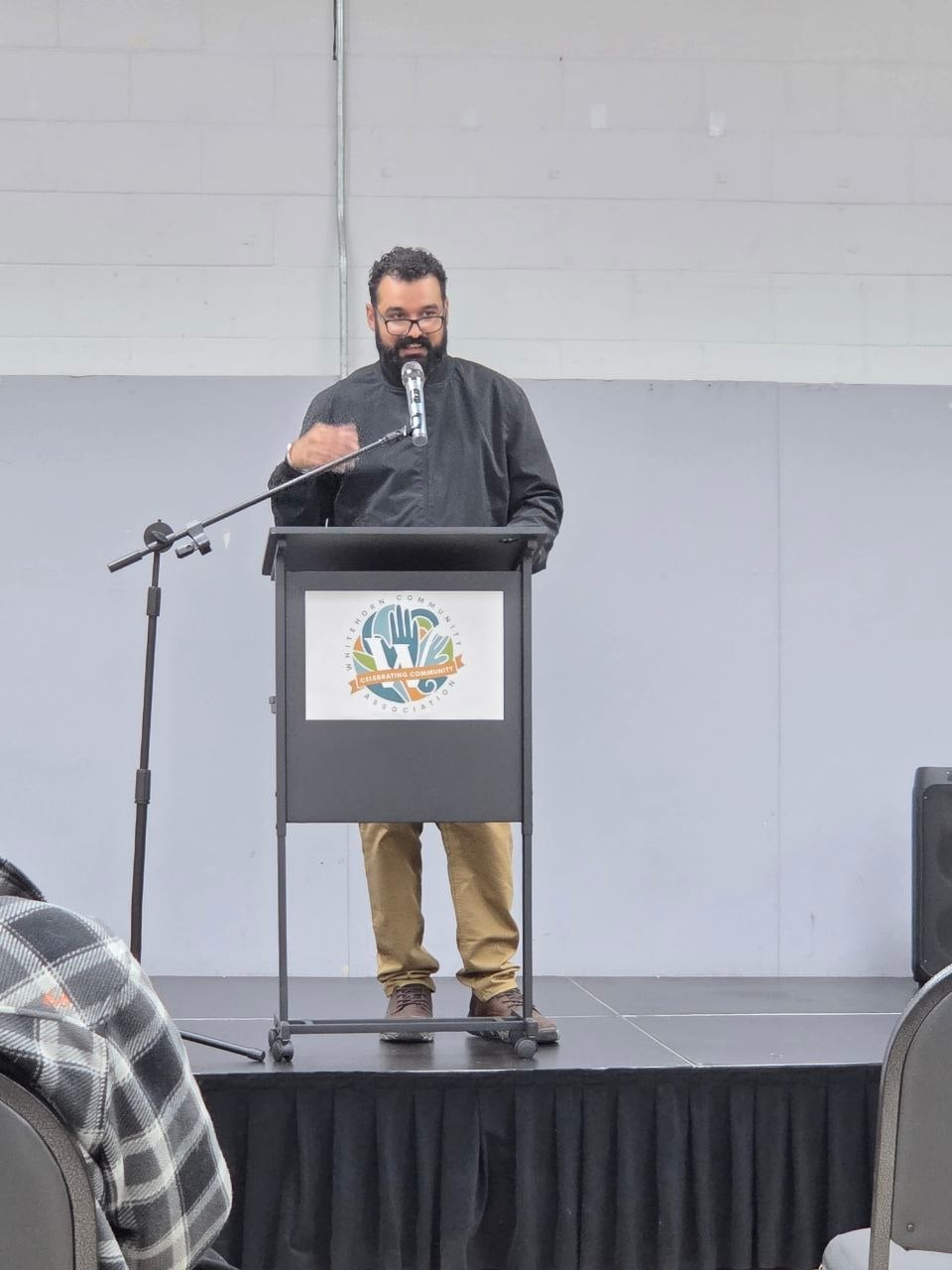 A speaker addressing the room from the Whitehorn Community Association podium
