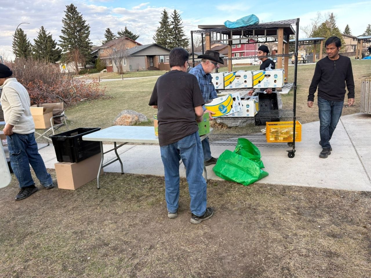Volunteers setting up tables of food outdoors