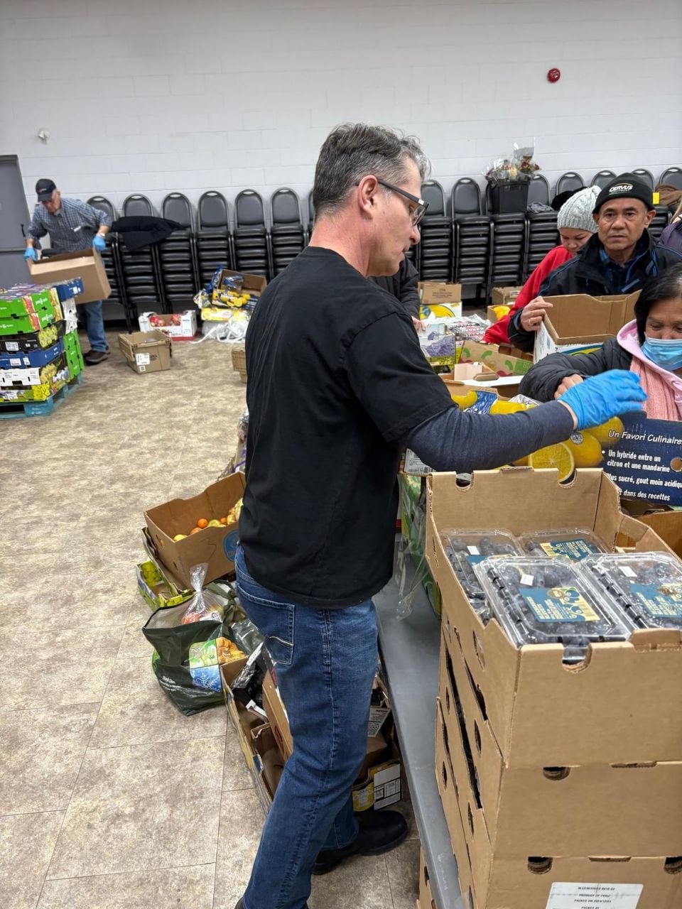 A volunteer packing boxes of fresh produce