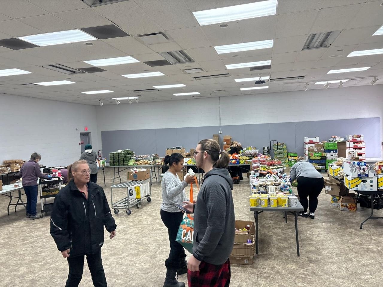 The hall set up with tables of food for a distribution