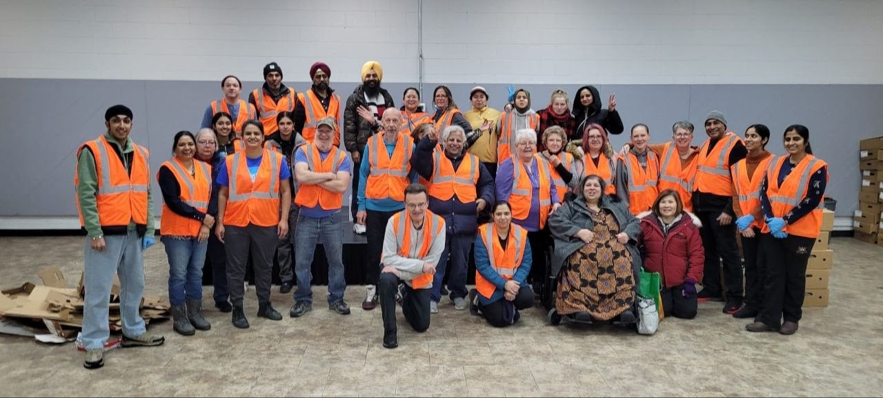 Whitehorn volunteers in orange vests gathered for a group photo in the hall